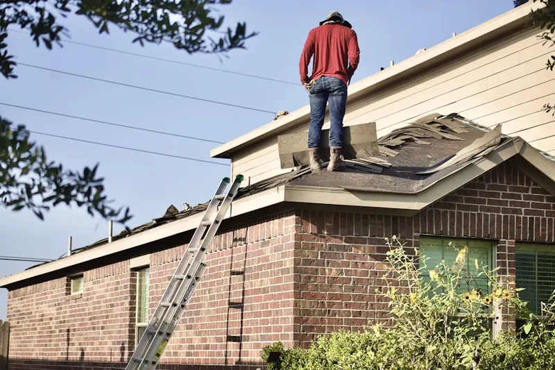 Professional roofer working on a residential roof in Camryn's Crossing